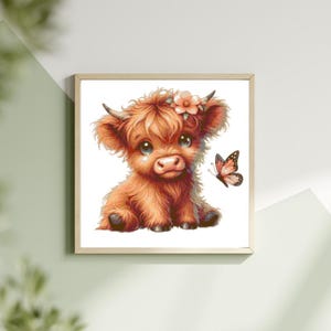 May include: A framed watercolor print of a Highland cow calf with a flower crown and a butterfly. The calf is brown with fluffy fur and big eyes. The butterfly is orange and brown. The print is in a light wood frame.