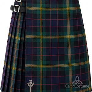 May include: A tartan kilt in green, navy, and yellow, secured with black leather straps and silver buckles. It has a pleated design and a silver thistle pin. The Celtic Costume logo is visible on the bottom right.