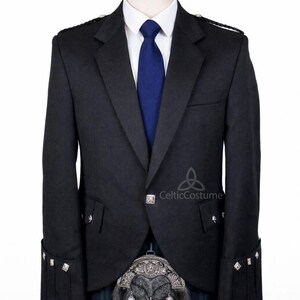 May include: A dark grey formal jacket with silver detailing, a white shirt, and a blue tie. The jacket is worn with a traditional tartan kilt and a decorative sporran. The outfit is displayed on a mannequin.