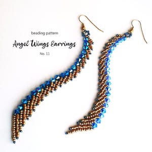 Könnte beinhalten: Ein Paar Perlenohrringe in Gold- und Blautönen. Die Ohrringe sind in Form von Engelsflügeln gestaltet und aus kleinen, facettierten Perlen gefertigt. Die Ohrringe sind mit "Angel Wings Earrings No. 11" beschriftet.