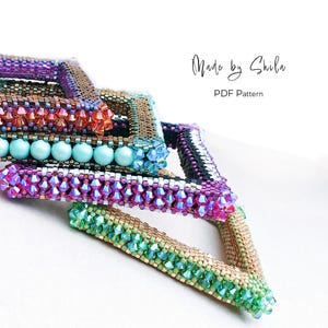 Può includere: Primo piano di diversi braccialetti di perline in vari colori, tra cui viola, verde e oro. Alcuni braccialetti presentano perline iridescenti e perle turchesi. L'immagine include il testo "Made by Shila" e "PDF Pattern".
