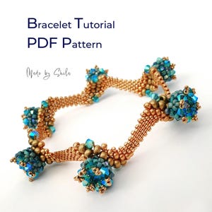 May include: A beaded bracelet featuring a wavy design made of metallic bronze seed beads, accented with clusters of iridescent blue and teal crystals. The text "Bracelet Tutorial PDF Pattern" and "Made by Shila" appear above the bracelet.