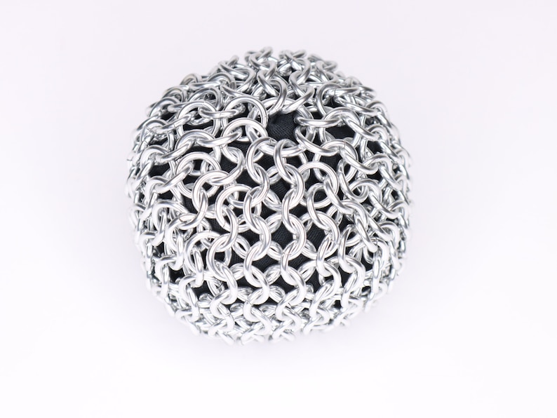 An example of a finished silver chainmail ball against a white background.