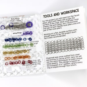 A photo of the diy kit opened to the first page. On the inside of the cover you can see the materials of the kit wraped in plastic bags. The first page features black text on a white page and describes the tools needed for the project, two pairs of pliers, and a brief history of chainmail.