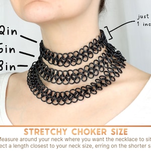 Three oversized tattoo chokers of increasing lengths sit at different heights on a models neck. The necklaces are just under 1 inch wide. To choose your size; measure around your neck where you want the necklace to sit. Select a length closest to your neck size, erring on the shorter side. The 12 inch necklace sits in the middle of the models neck, the 15 inch sits just a little lower, and the 18 inch sits over the models collarbones.