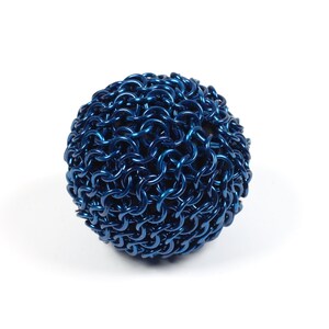 An example of a finished chainmail ball made with blue anodized aluminum against a white background.