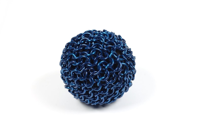 An example of a finished chainmail ball made with blue anodized aluminum against a white background.