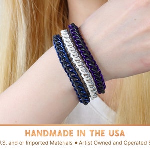 Three chain bracelets in black, white, and purple, stacked on top of each other. Handmade in the USA From U.S. and or Imported Materials in an Artist Owned and Operated Shop.