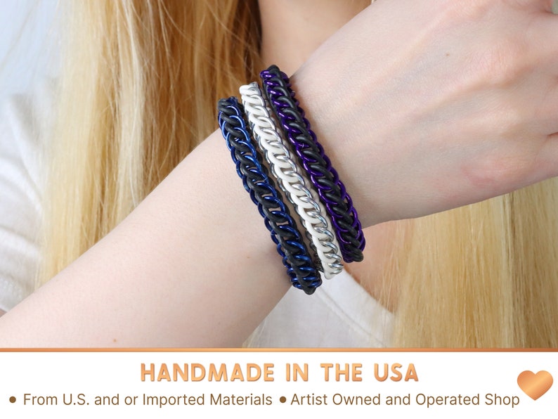 Three chain bracelets in black, white, and purple, stacked on top of each other. Handmade in the USA From U.S. and or Imported Materials in an Artist Owned and Operated Shop.