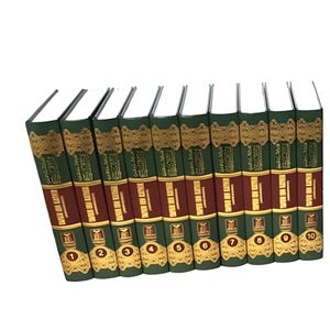 May include: A set of ten books with green and maroon covers. The spines feature gold lettering and Arabic script. Each book is numbered from one to ten. The books are likely part of a collection or series.