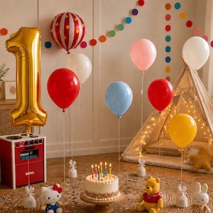 May include: A birthday celebration scene featuring a large gold foil number one balloon, a red and white striped balloon, and various solid-colored balloons in red, white, pink, blue, and yellow. A cake with lit candles sits on a wooden stand.