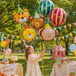 May include: A young girl holds a collection of animal-shaped balloons, including a tiger, bear, lion, and monkey, with party hats. Other balloons and a circus tent are in the background. A table with a cake and the words "Happy Birthday" is also visible.