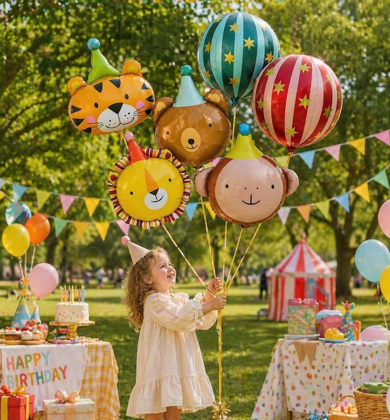 May include: A young girl holds a collection of animal-shaped balloons, including a tiger, bear, lion, and monkey, with party hats. Other balloons and a circus tent are in the background. A table with a cake and the words "Happy Birthday" is also visible.