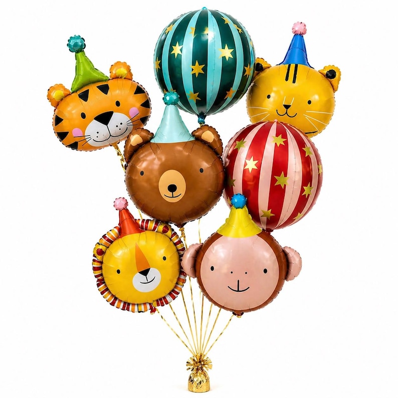 May include: A bouquet of foil balloons in the shape of animal faces, including a tiger, bear, lion, and monkey, each wearing a party hat. Additional round balloons feature stripes and stars. The balloons are tied together with gold ribbon.