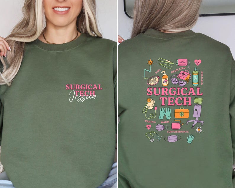 May include: An olive green sweatshirt with the text "SURGICAL TECH Jessica" in pink on the front. The back features a colorful graphic with medical-related icons and the words "SURGICAL TECH".