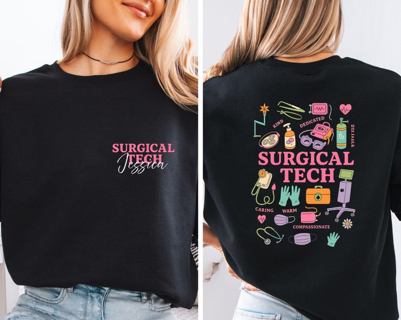 May include: Black sweatshirt with the text "SURGICAL TECH Jessica" in pink on the front. The back of the sweatshirt features colorful medical-themed illustrations and the words "SURGICAL TECH".