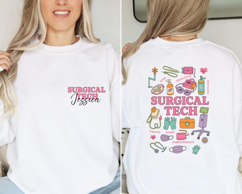 May include: White sweatshirt with the text "SURGICAL TECH Jessica" in pink and black script on the front. The back features colorful medical-themed illustrations and the words "SURGICAL TECH".