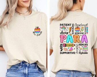 May include: Beige t-shirt with a colorful apple graphic and the text "Mrs. Smith" on the front. The back features the word "PARA" in large, colorful letters, surrounded by words like "Loving," "Kind," and "Reliable."