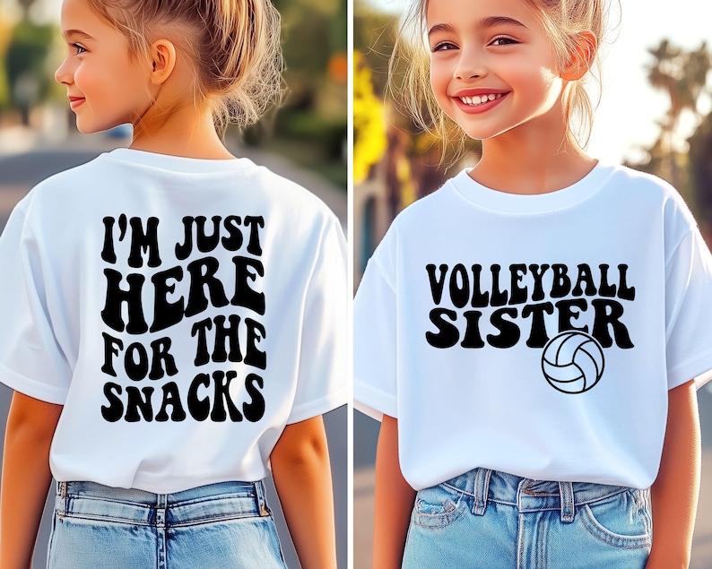 May include: Two white t-shirts with black text. One says "I'M JUST HERE FOR THE SNACKS" on the back. The other says "VOLLEYBALL SISTER" with a volleyball graphic. Both shirts are worn by a young person.