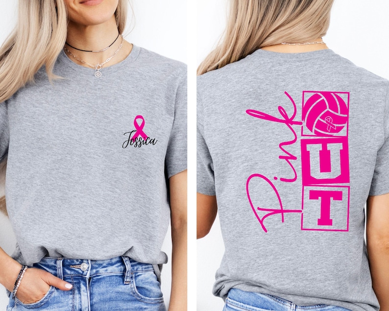 May include: A heather gray t-shirt with a pink ribbon and the name "Jessica" printed on the front. The back of the shirt features the words "Pink UT" with a volleyball graphic, all in pink. The shirt is a casual style.