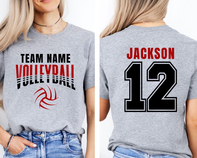 May include: A heather gray volleyball t-shirt with the words "TEAM NAME VOLLEYBALL" in black and red, and a volleyball graphic. The back of the shirt displays "JACKSON 12" in black and red.