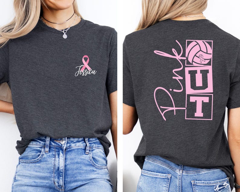 May include: Dark gray t-shirt with a pink ribbon and the name "Jessica" printed on the front. The back of the shirt features the word "Pink" in cursive, along with a volleyball and the letters "UT" in pink.