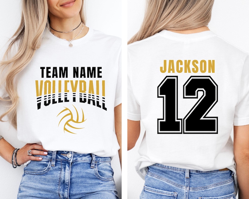 May include: White t-shirt with a volleyball design. The front features "TEAM NAME VOLLEYBALL" in black and gold lettering, with a volleyball graphic. The back displays "JACKSON 12" in gold and black.