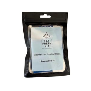 May include: A black pouch with a blue and white label that says "Fly Fresh Kit". The label also says "Freshness that travels with you." and "Single use travel kit."