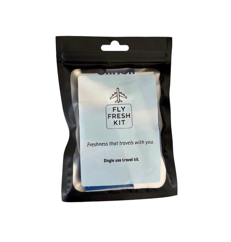 May include: A black pouch with a blue and white label that says "Fly Fresh Kit". The label also says "Freshness that travels with you." and "Single use travel kit."