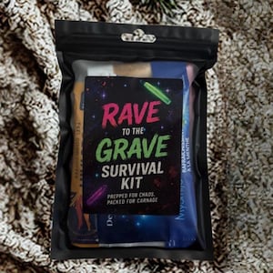 May include: A black plastic bag containing a "Rave to the Grave Survival Kit". The kit includes various items, with the text "PREPPED FOR CHAOS, PACKED FOR CARNAGE". The bag is on a textured, neutral-toned surface.