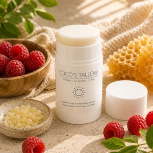 May include: A white cylindrical tube of Coco's Tallow sun balm with a removable cap. The label reads Coco's Tallow, Sun Balm, All Natural, 75 ml, and lists ingredients including grass-fed beef tallow, beeswax, raspberry seed oil, and zinc oxide.