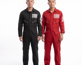 May include: A black jumpsuit and a red jumpsuit, each featuring a white barcode graphic on the chest, a white tribal-style logo on the left sleeve, a collared neckline, long sleeves, and two zippered chest pockets, presented as a matching set.