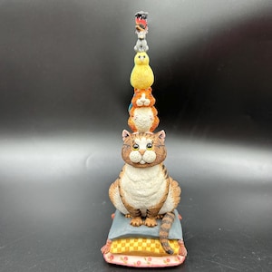 May include: A set of three ceramic mugs with a speckled, matte finish. Each mug features a different color: light blue, cream, and gray. The mugs have a simple, modern design and a comfortable handle. Perfect for coffee or tea.