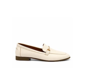 May include: A cream-colored leather loafer featuring a smooth finish, a rounded toe, and a gold-toned metal horsebit detail across the vamp. The shoe is constructed with a low, flat brown heel and a matching brown sole for a clean profile.