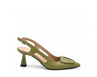 May include: An olive green slingback pump featuring a pointed toe, a decorative rectangular buckle detail on the vamp, a cutout side design, and a flared kitten heel. The shoe includes an adjustable ankle strap with a silver-toned metal buckle.
