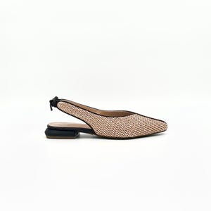 May include: A pair of light pink woven slingback flats with a black heel and a black strap. The shoes have a pointed toe.