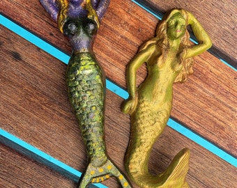 Cast Iron Mermaids ink stained and can come in all colors. Custom on colors Bottle opener and Mermaid hook. Embellished Sea Goddess.