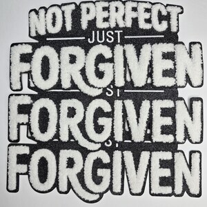 May include: A black and white patch with the words "NOT PERFECT JUST FORGIVEN" in a layered design. The text is in a bold, textured font, with white lettering on a black background. The patch is likely for clothing or accessories.
