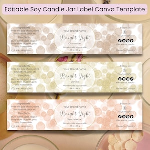 May include: Three rectangular candle jar label templates with the text "Editable Soy Candle Jar Label Canva Template". Each label features a different scent: Cinnamon, Vanilla, and Sandalwood. The labels include space for a brand name, ingredients, and social media icons.