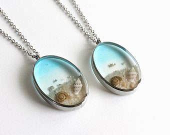 Clear Blue Seashell and Beach Sand Oval Pendant Necklace