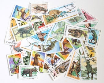 25 or 50 dinosaurs and extinct animal cancelled stamps