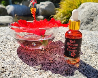 Röd hibiskusblomessens