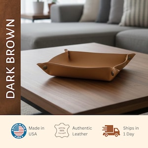 a brown leather tray placed on a wooden table, with a focus on the tray and the surrounding furniture.