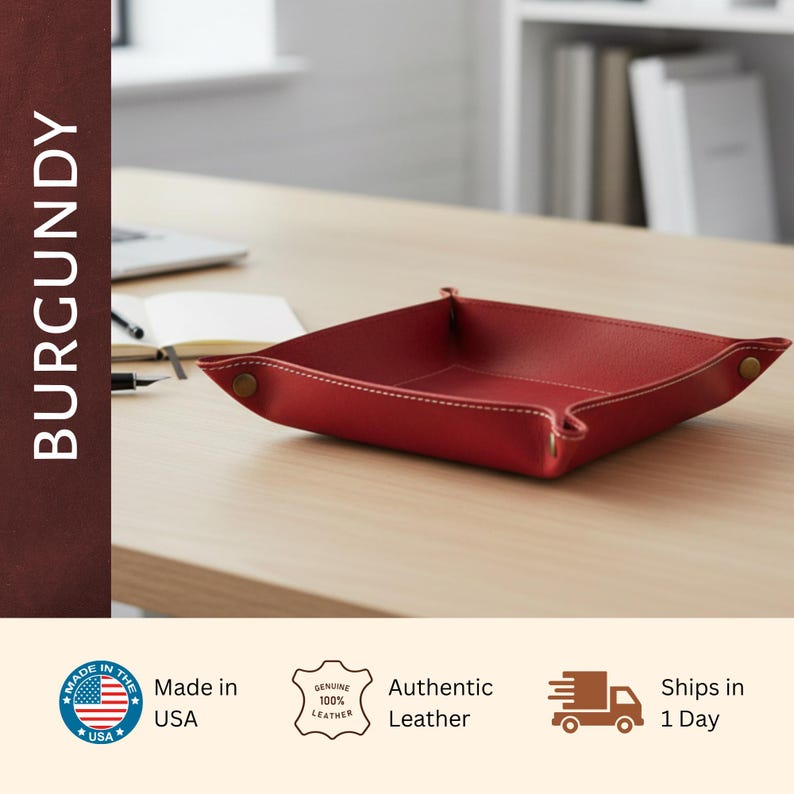 a burgundy leather desk organizer on a wooden desk, with a laptop and other office supplies visible in the background.