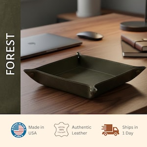 a wooden desk with a laptop, mouse, and a leather tray. The text on the image includes "FOREST", "Made in USA", "Genuine Leather", "Authentic Leather", and "Shipped in 1 Day".