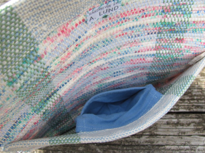 Upcycled Fabric Clutch Wallet, Boho Cloth Purse Pastel Wristlet Hand Bag, Handmade Hand Woven Zero Waste Sustainable Eco Vegan Recycled Accessories, Travel Jewelry Phone Pouch, Casual Spring or Summer Slow Fashion Accessory Handcrafted by Amy C. Lund in Pastel Pink, Green, Blue and Cream White with Button Accent. Showing detail of small inside pocket.