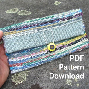 May include: A colorful woven clutch with a gray fabric flap and a yellow button. The text "PDF Pattern Download" is printed below the clutch.