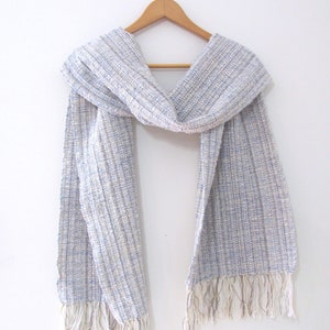 Handmade Light Blue Chalcedony Artisan Hand Woven Scarf Shawl or Table Runner for Positive Natural Energy, Spiritual Serenity, Harmony, Grounding Meditation Prayer is a Gender Neutral Unisex Men's Women's Long Fall, Winter, Spring, Urban Casual Rustic Fashion Accessory Wrap or Home Decor Accent Handcrafted by Amy C. Lund in Cotton Blend. Styled on a hanger.