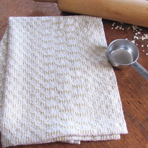 Handcrafted Butter Cream Artisan Hand Woven Cotton Kitchen Dish Towel, Gourmet Chef Gift or Home Cooking Baking Gift, Rustic Country French Cottage Modern Farmhouse Cookware or Kitchenware Decor Accessory.  Styled with a metal measuring cup. a wooden rolling pin, oats.