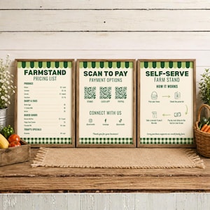May include: Three framed signs with a green and white gingham border. The first sign lists farmstand produce prices. The second sign displays QR codes for payment options and social media handles. The third sign outlines self-serve farm stand steps.